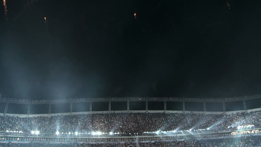 People clap and cheer as fireworks explode overhead marking the end of the 2008 Democratic National Convention at Investco Field in Denver Colorado.
