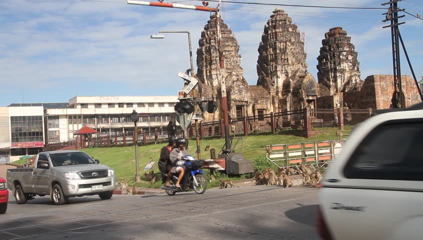 LOPBURI, THAILAND - CIRCA SEPTEMBER 2011 - Cars crossing railway near Phra Prang Sam Yot circa September 2011.