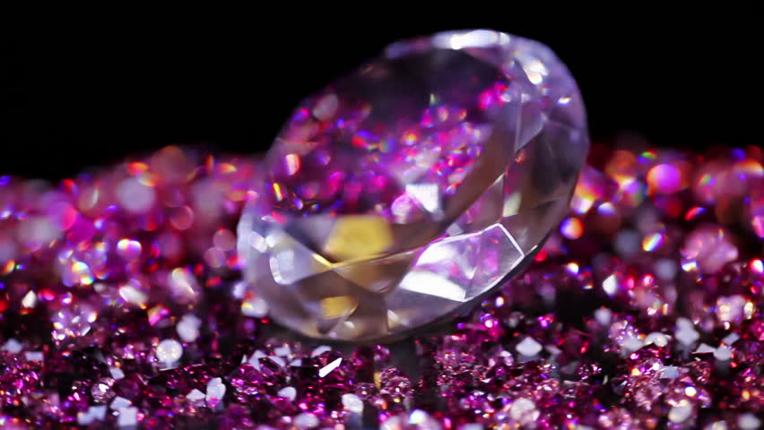 Big jewel stone with many violet small one rotating over dark background HD quality macro video
