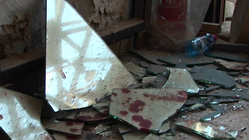 Blood-stained pieces of broken glass lie scattered after a suicide bombing in the Middle East.