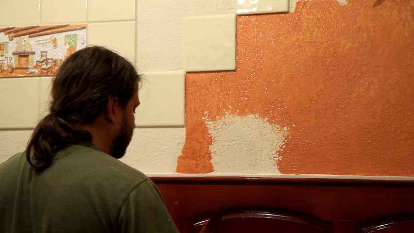 Master applies colored wax on ornamental plaster. 