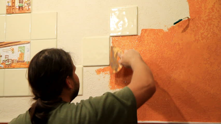 Master applies colored wax on ornamental plaster. 