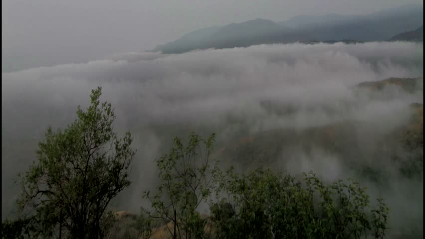 timelapse of a foggy day in the fall mountain