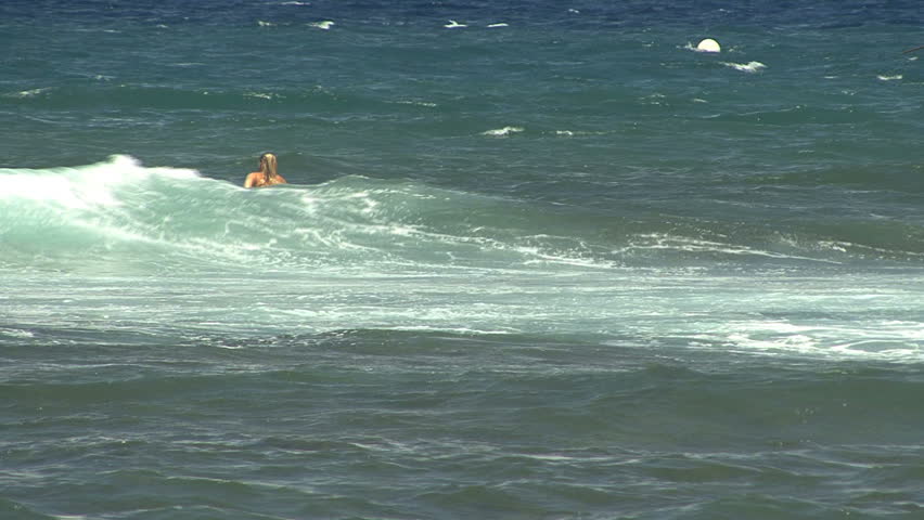 October 2011 - Hawaii - Surfboarder heads in to the waves