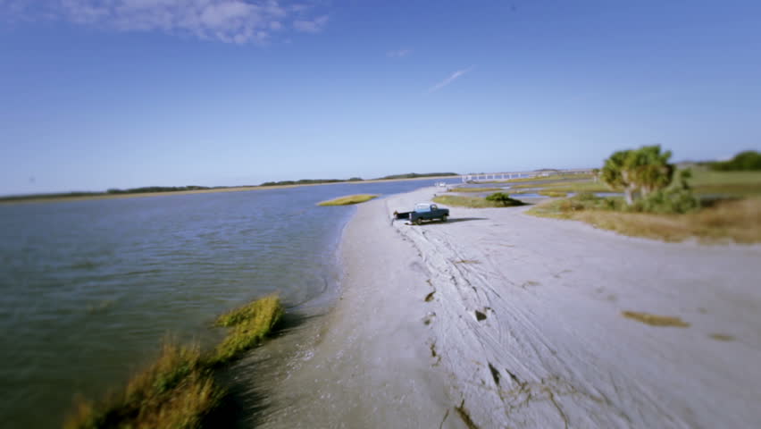 Aerial flyover of Truck at Beach