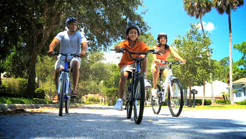 Healthy African American Family Cycling Together