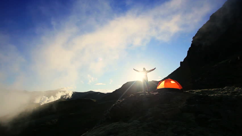 Female Celebrating Dawn Outside Expedition Tent