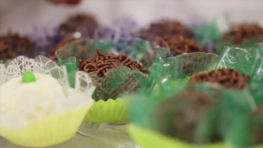 Close Up Of The Hands Of a Waitress Arranging Window With Sweeties