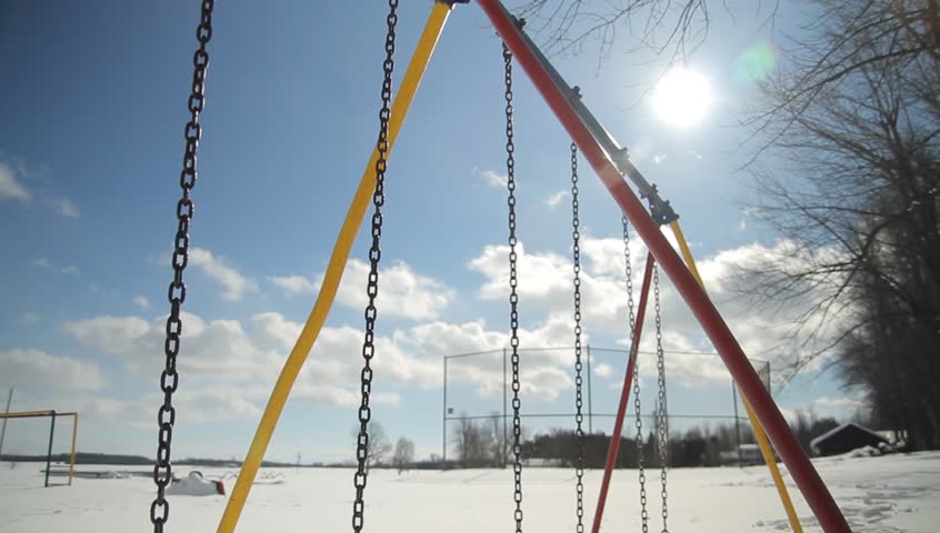 Swing seats buried in deep snow on playground