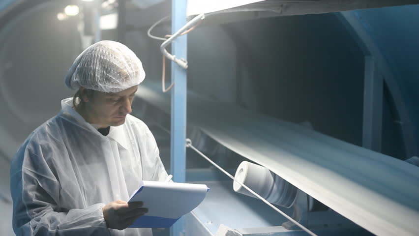 Worker controling quality of sugar on the production line