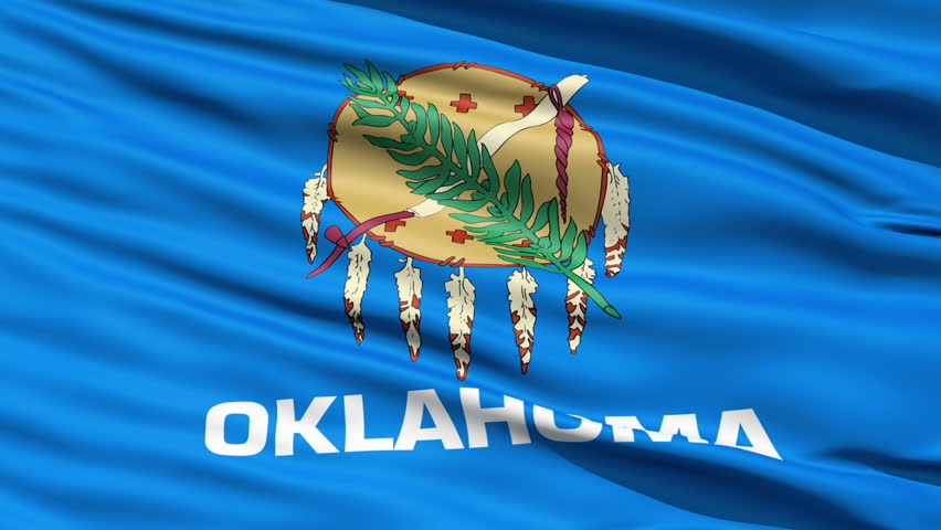 Waving Flag Of The US State of Oklahoma with a traditional Osage nation buffalo skin shield and eagle feathers.