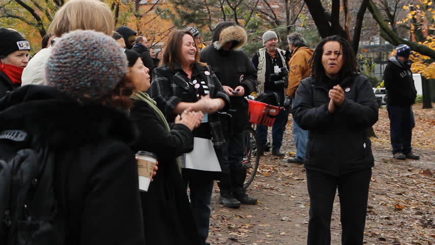 TORONTO, ONTARIO - NOV 23th: Protesters sing at Occupy Toronto on Nov 23rd, 2011, Toronto, Ontario, Canada. The site was closed down on Nov 23rd by police following a superior court judge ruling.