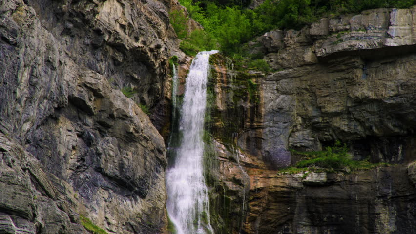 Tilt shot showing water falling down the full height of Bridal Veil Falls in Provo Canyon, Utah.