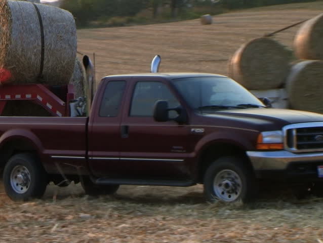 Trucks Hauling Hay Bales 