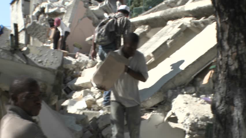 PORT-AU PRINCE, HAITI - CIRCA 2010: people transporting goods from ruins circa 2010 in Haiti.