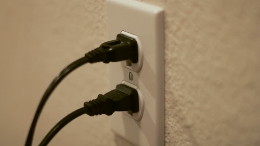 Unplugging a black power cord from a white power outlet and then plugging it back in