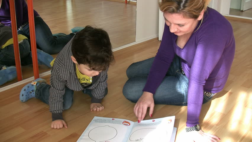 Teacher and little boy in kindergarten