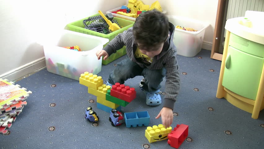Little Boy playing toys in the kindergarten