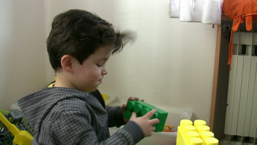 Little Boy playing toys in the kindergarten