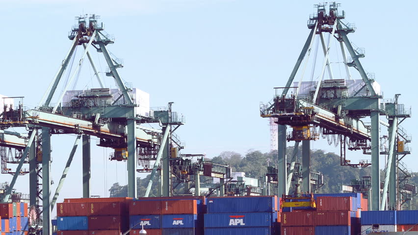 Singapore - November 25, 2009: (Timelapse View) Gantry cranes unload containers from a freight ship (not visible) at PSA industry harbor in Singapore. 
