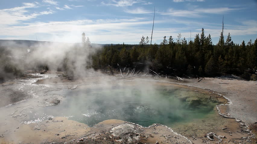 Water geyser in the Norris Geyser Basin, Yellowstone National park, Wyoming. Emerald Springs. Hot steam geothermal feature.