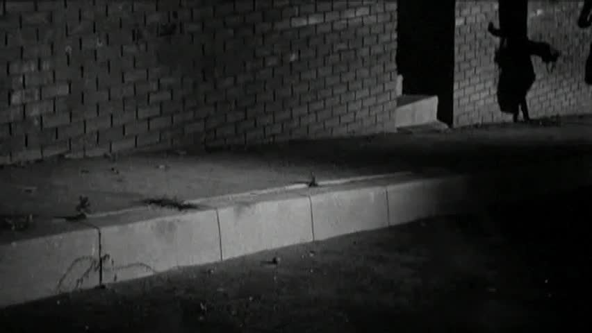 Low angle view of man chasing woman at night