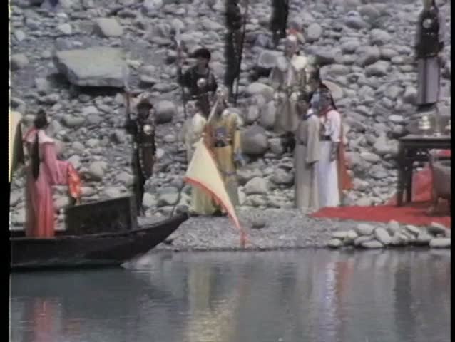 Asian person on houseboat floating down river