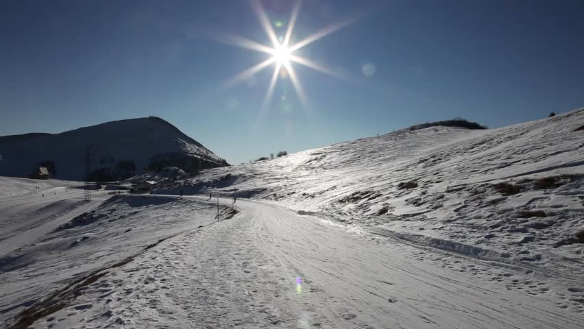 People skiing on a narrow track