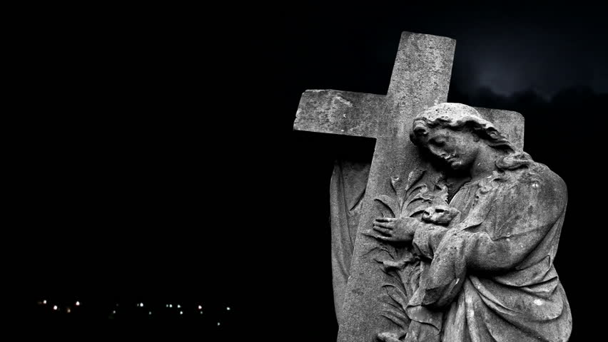 Graveyard statue set against storm clouds with lightning strikes