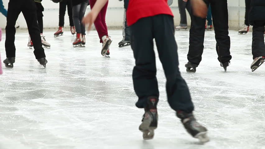 crowd of Ice skaters at a public ice skating rink, Medium Shot, Rear View 