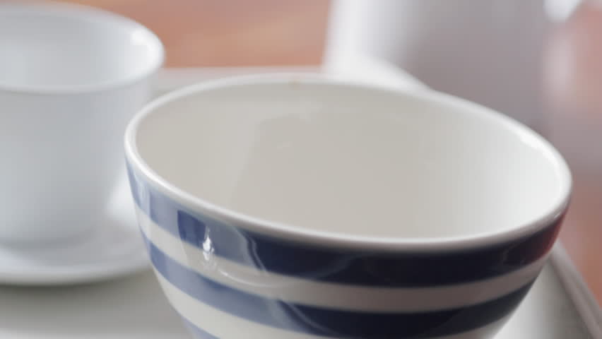Cornflakes being poured into breakfast bowl