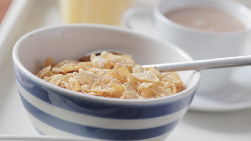 Pouring milk on cereal