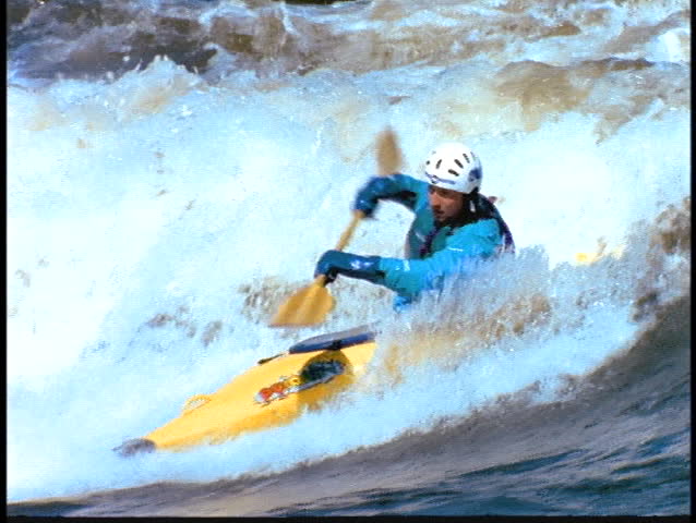 A man moves through rapids in a kayak.