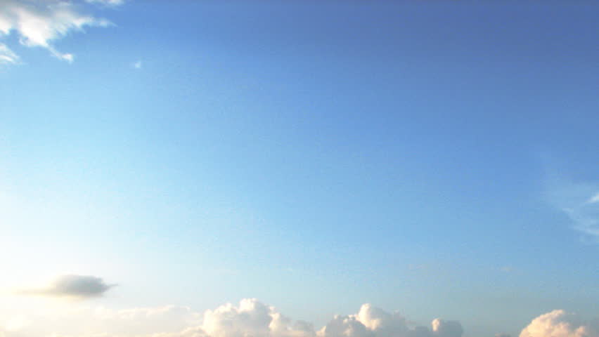 Time lapse of white clouds over blue sky