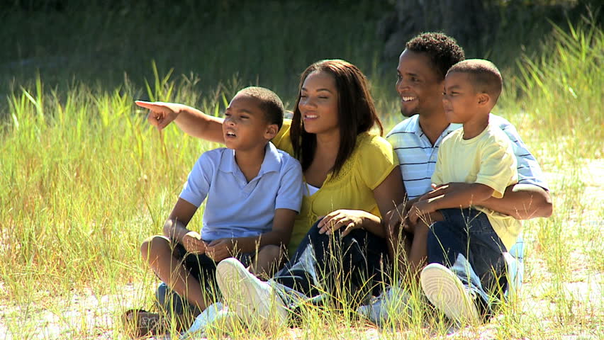 Portrait of happy young african american family enjoying the park