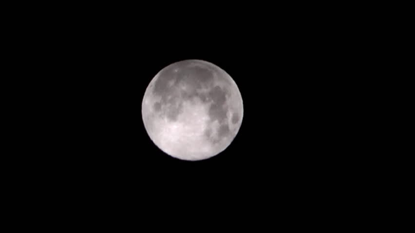 The full white moon with increase in 20 times and night clouds covering it