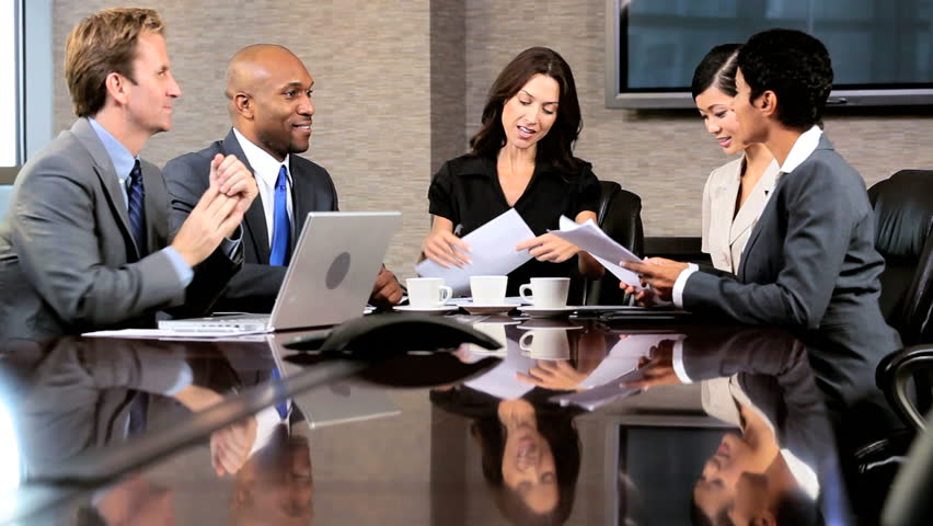 Female caucasian business executive in a boardroom meeting with her multi ethnic business team