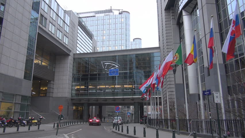 BRUSSELS, BELGIUM - DECEMBER 19 2011: Unidentified people and cars pass near to European Parliament 