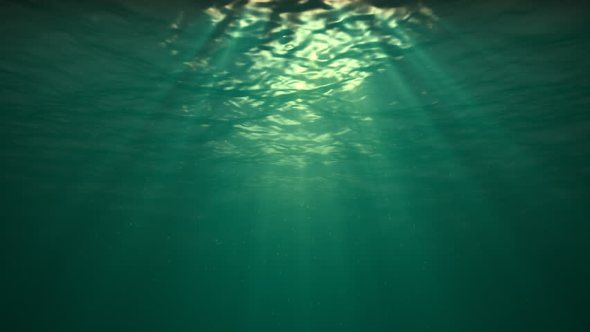 Blue version, water ripples coming towards camera. With tiny particles in the water. Sun rays shinning down. Seamless looping video animation.-