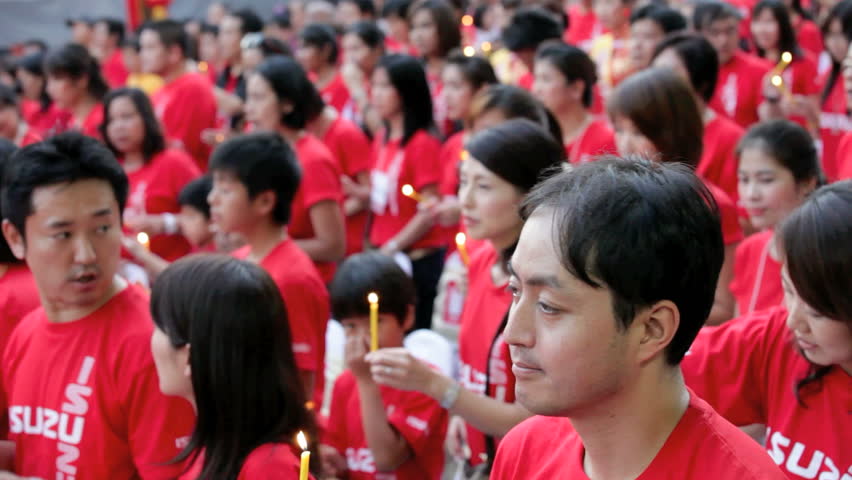 BANGKOK - JANUARY 24, 2012: People are singing during the Chinese New Year celebration in Bangkok Chinatown on January 24, 2012. Part of the event is sponsored by Isuzu.