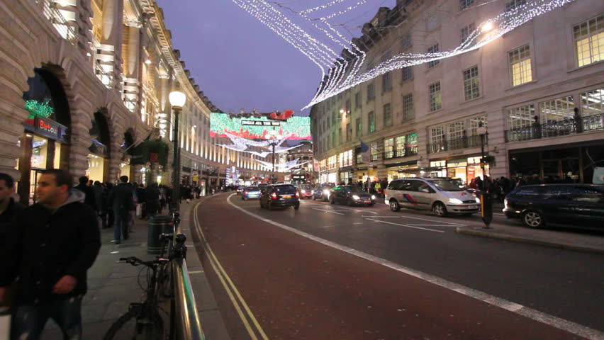 LONDON, UK - DECEMBER 27: Busses and other traffic drive beneath Christmas lights on Regent Street on December 27, 2011 in London, UK. Regent Street is one of the main shopping streets of London.