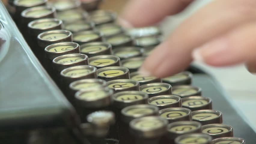 Woman typing on antique typewriter