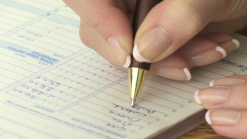 Woman's hands tracking household expenses