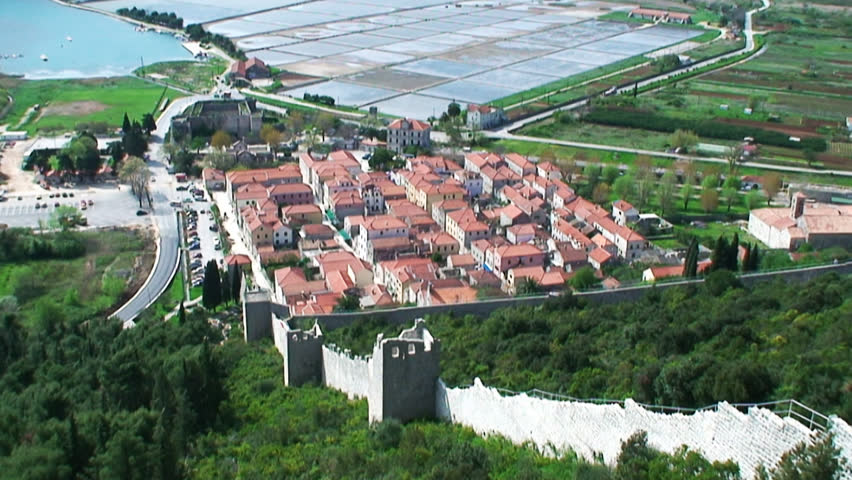 Second longest world walls. Ston small town near Dubrovnik with medieval Salt Basin, Croatia landscape in wide pan shot from top of the hill fortress.