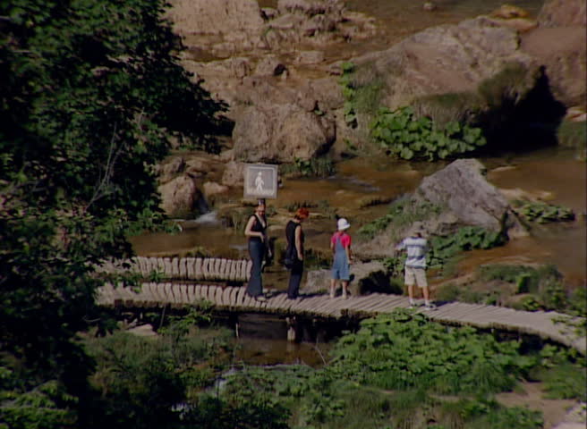 Tourist on a footpath walking and looking to the waterfalls and lakes in National park Plitvicka jezera circa July 2000 in Plitvice Lakes. 