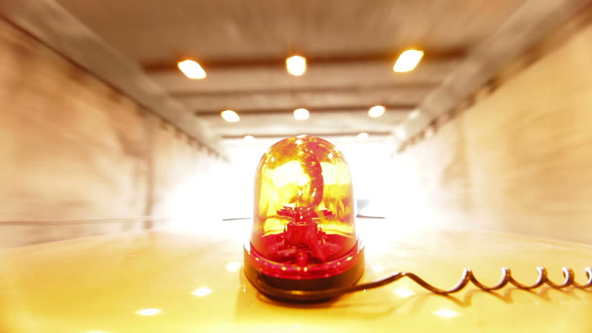 Car With Red Emergency Light Driving Through A Tunnel