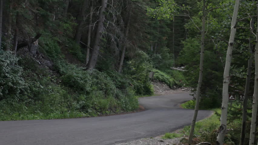 A pickup driving down a winding road