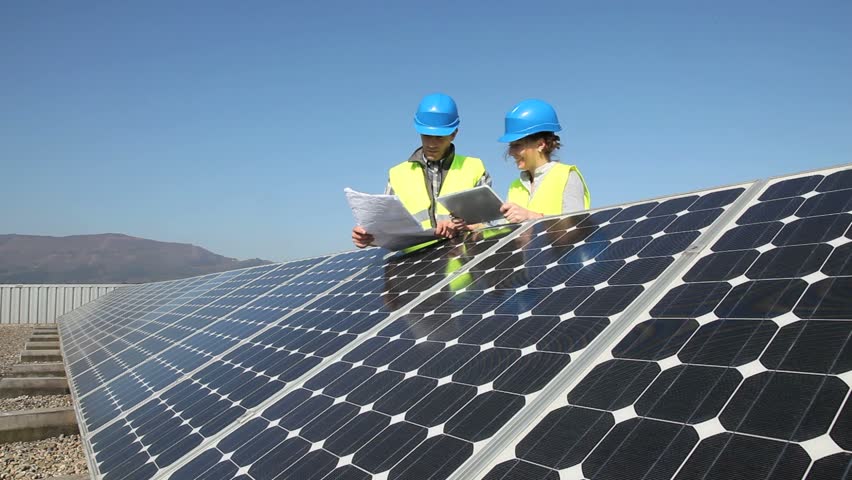 Engineers working on solar panels plant