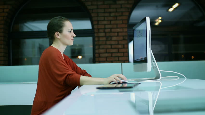 Woman surfing the net on computer in modern office