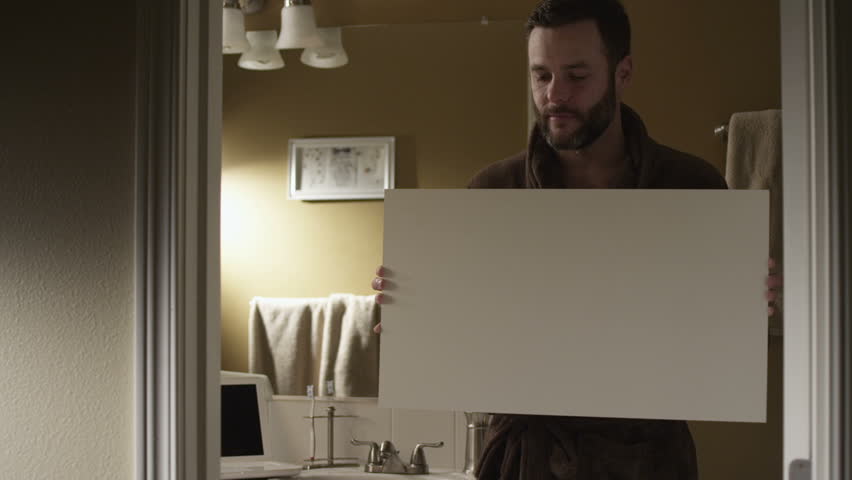 A couple  balancing home life and professional life. Authentic moments around the house are captured as the couple gets ready for the day, completes work on the computer.